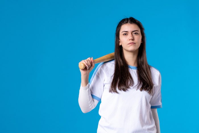 Young girl using baseball bat for protection